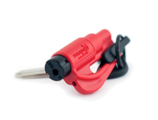 A red ResQMe safety tool, featuring a compact design with a built-in seatbelt cutter and window breaker. The tool is designed for emergency situations and can be easily carried in a car or on a keychain